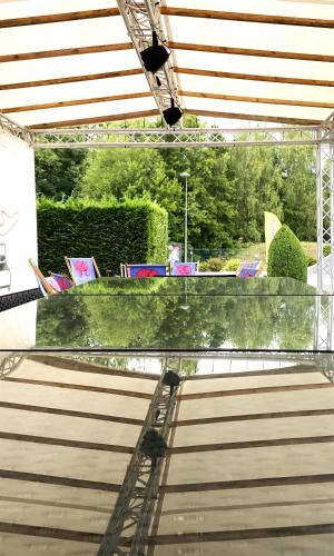 a covered patio with a table and chairs at Ibis Styles Charleroi Airport Aero 44 in Charleroi