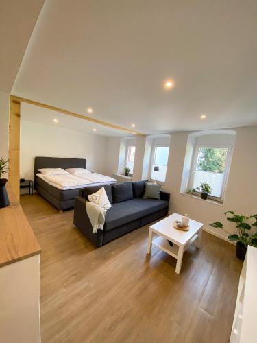 a living room with a bed and a couch at Fewo Catlen in Traben-Trarbach
