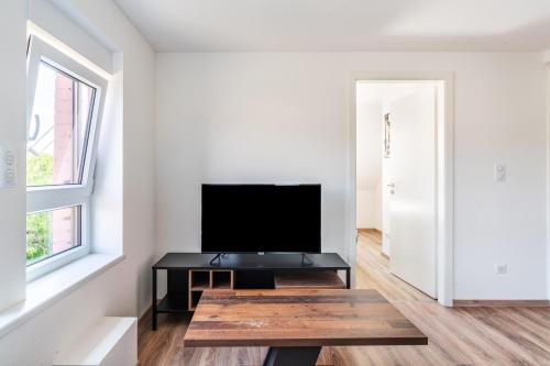 a living room with a tv and a coffee table at Gemütlich 6 in Wissembourg