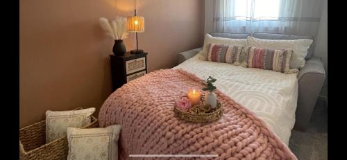 a bedroom with a bed with a candle on it at Stylish Scottish House with garden and parking in Perth
