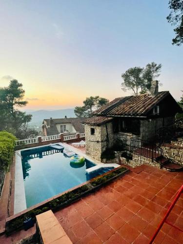 uma grande piscina em frente a uma casa em Casa de las Mariposas em Vallirana