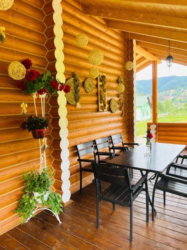 a dining room with a table and chairs in a cabin at Шале Вілія in Vorokhta