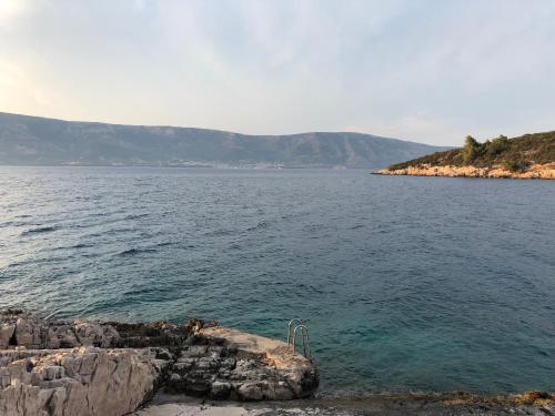 a large body of water with mountains in the background at Hvar island -Enjoy Your privacy by the sea in Stari Grad