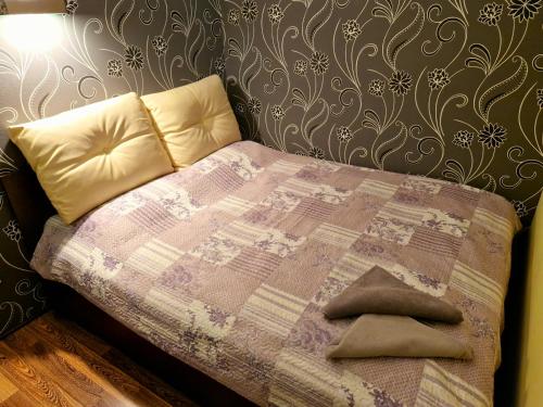 a bed with two pillows on it in a bedroom at M&M Apartment II SELF CHECK-IN in Panevėžys