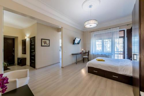 a bedroom with a bed and a desk in a room at Однокімнатні апартаменти на Майдані, дистанційне заселення 24х7 in Kyiv