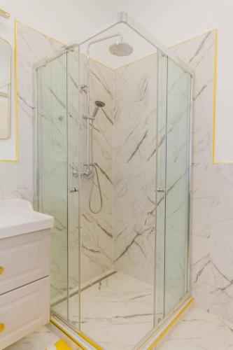 a shower with a glass enclosure in a bathroom at Bengt Apartment Kiraly str. in Budapest
