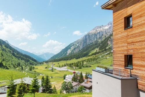 a view of a valley from a building at Mondschein Hotel & Chalet Ski-In Ski-Out Luxus am Arlberg in Stuben am Arlberg