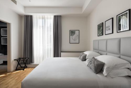 a bedroom with a large white bed with two pillows at AT FORTY-ONE in Rome