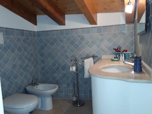 a bathroom with a sink and a toilet at Sweet Dream House in Carloforte