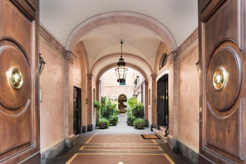 an alleyway with arches and plants in a building at AT FORTY-ONE in Rome