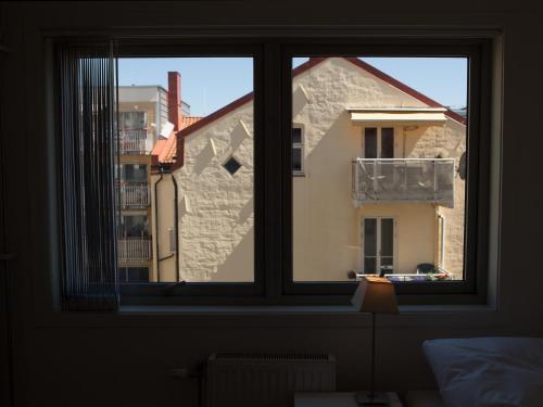 a window with a view of a building at BJØRVIKA APARTMENTS, Teaterplassen, Oslo city center in Oslo