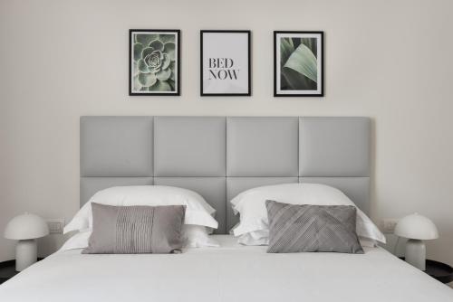 two beds in a bedroom with three pictures on the wall at AT FORTY-ONE in Rome
