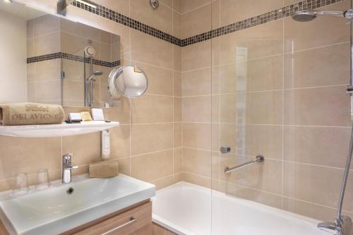 a bathroom with a shower and a sink at Hôtel Delavigne in Paris