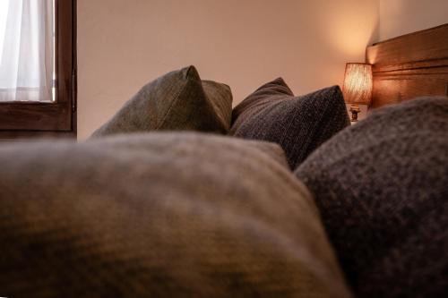 a close up of a couch with pillows on it at Hotel Mas de Xaxas in Camprodon