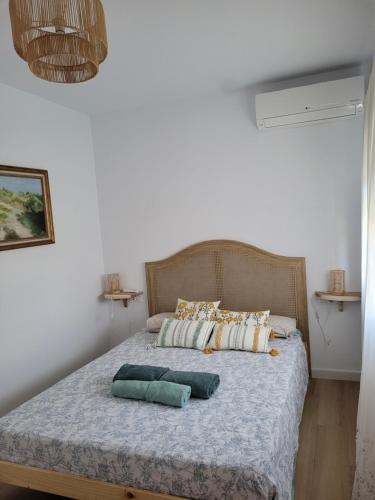 a bedroom with a bed with two pillows on it at Casa cerca de Sevilla con piscina in Valencina de la Concepción