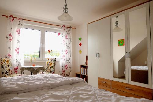 a bedroom with a bed and a dresser and a window at Ferienwohnung Mechernich-Eifel in Mechernich