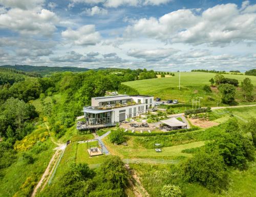 an aerial view of a large white building in a field at Boutiquehotel Genusswerk Eifel in Körperich