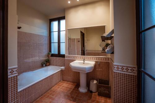 a bathroom with a tub and a sink and a bath tub at Hotel Mas de Xaxas in Camprodon