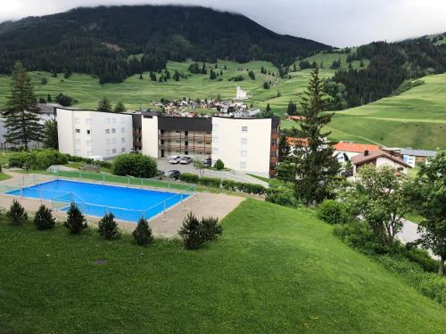 an aerial view of a resort in a green field at Tgesa Tgampi T20 in Savognin