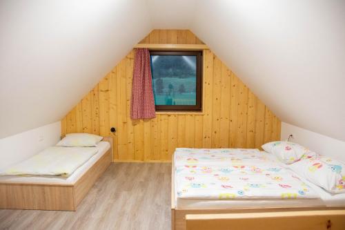 a bedroom with two beds in a attic at Farmhouse Soklic in Bohinj