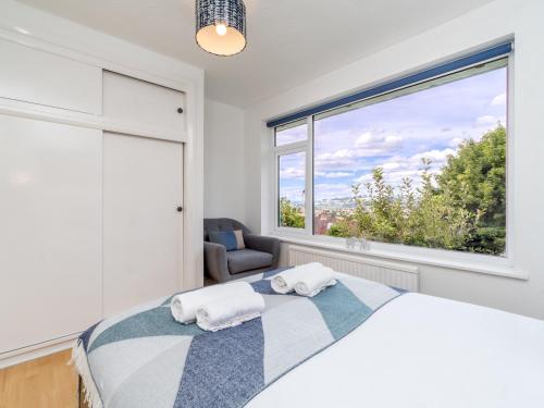 a bedroom with a bed and a large window at Pass the Keys One bed flat with stunning views and free parking in Bath