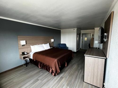 a hotel room with a bed and a television at Super 8 by Wyndham Fort Worth Entertainment District in Fort Worth
