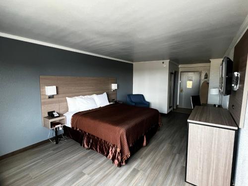 a hotel room with a bed and a television at Super 8 by Wyndham Fort Worth Entertainment District in Fort Worth