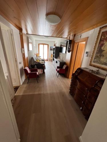 a living room with wooden floors and a living room with a couch at Palazzo Cervesato Appartamento: Maria Luisa in Santo Stefano di Cadore