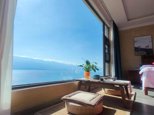 a room with a large window with a view of the water at Super Invincible All Seaview Villa in Dali