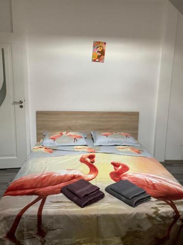a bedroom with a bed with two flamingos on it at New and modern, 2 rooms cozy apartment in Timişoara