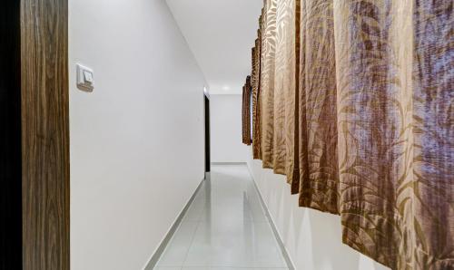 a hallway with a row of curtains on a wall at Treebo Elite Premium Homes in Bengaluru
