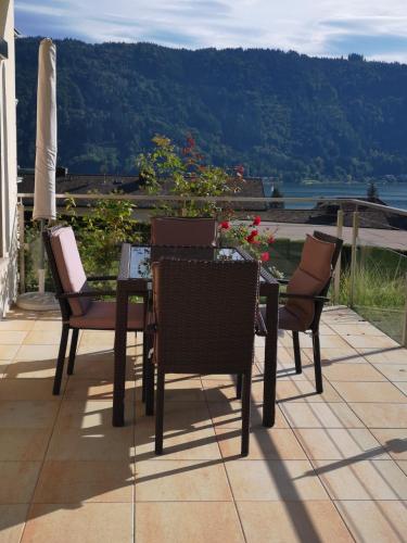 a table and chairs sitting on top of a patio at Ferienwohnungen Kircher Villa Baudisch in Sattendorf