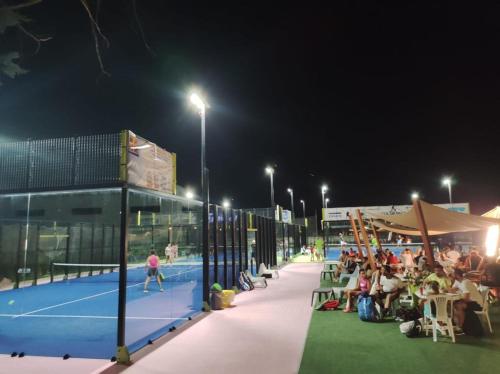 a tennis court at night with a group of people at Hotel Select in Atessa
