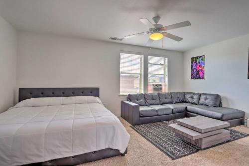 a bedroom with a bed and a couch and a ceiling fan at Spacious Denver Townhome Near Central Park! in Denver