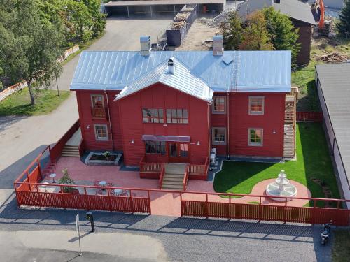 an aerial view of a red house with a blue roof at Hotelli-Ravintola Alma in Seinäjoki