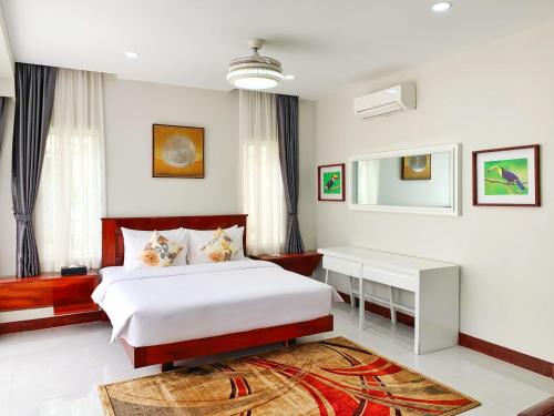um quarto com uma cama e uma secretária. em My Key Premier Palace Private Villa em Siem Reap