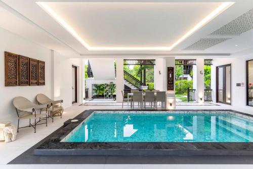 a villa with a swimming pool in a house at Sclass 2 Luxe Pools Villa & Breakfast , city area in Chiang Mai