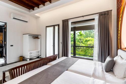 a bedroom with a large bed and a large window at Sclass 2 Luxe Pools Villa & Breakfast , city area in Chiang Mai