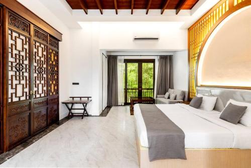 a bedroom with a large bed and a couch at Sclass 2 Luxe Pools Villa & Breakfast , city area in Chiang Mai