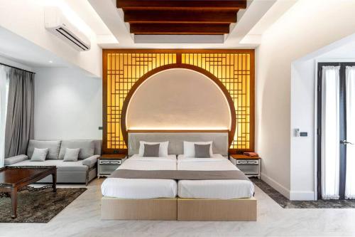 a bedroom with a large bed and a couch at Sclass 2 Luxe Pools Villa & Breakfast , city area in Chiang Mai