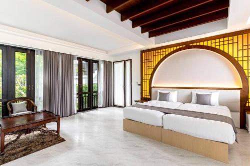 a bedroom with a large bed and a table at Sclass 2 Luxe Pools Villa & Breakfast , city area in Chiang Mai