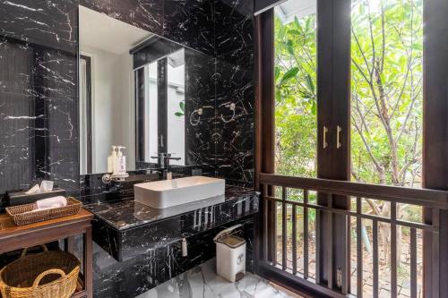 a black bathroom with a sink and a window at Sclass 2 Luxe Pools Villa & Breakfast , city area in Chiang Mai