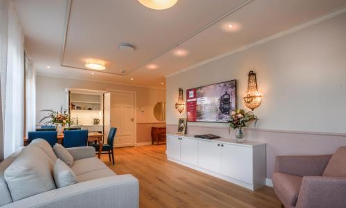 a living room with a couch and a table at Hotelli-Ravintola Alma in Seinäjoki