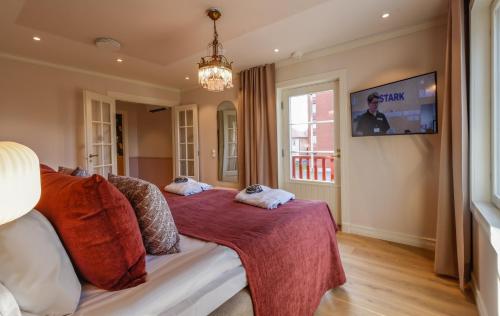 a bedroom with a bed and a tv on the wall at Hotelli-Ravintola Alma in Seinäjoki