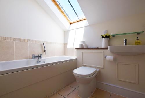 a bathroom with a toilet and a sink and a bath tub at 15 Crabshell Heights in Kingsbridge