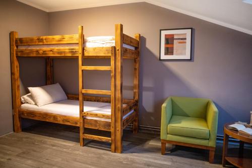 a room with a bunk bed and a chair at Pension Vyhlídka in Klášterec nad Ohří