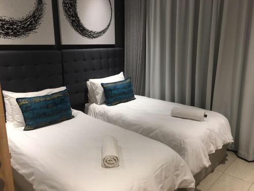 Ένα ή περισσότερα κρεβάτια σε δωμάτιο στο pearls umhlanga