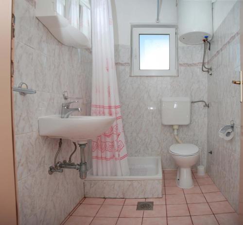 a bathroom with a sink and a toilet at Apartments Kraj, Tratica Beach in Kraj