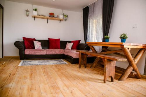 a living room with a couch and a table at Kućerak Sofija in Čortanovci