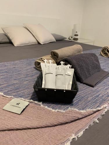 a bed with a tray of toiletries on it at Stadia Suite in Verona